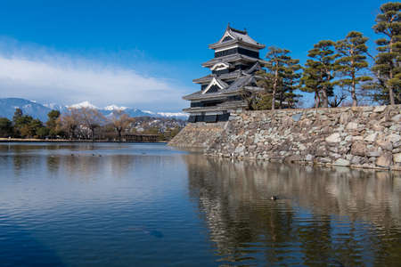 Matsumoto Castle in winter with beautiful snow-covered Northern Alps, Matsumoto Castle is listed as a National Treasure of Matsumoto, Japan.のeditorial素材