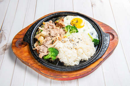 Korean-style teppanyaki with rice, eggs, vegetables,  grilled meatの写真素材