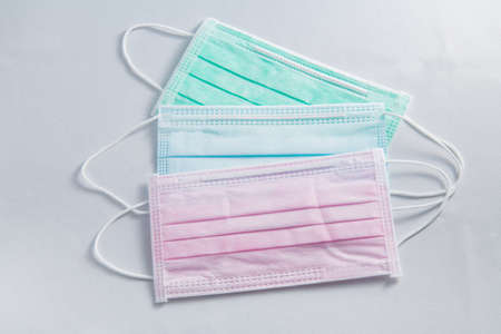 Pink, green and blue medical face mask and coronavirus protection isolated on a white background, covid-19の写真素材