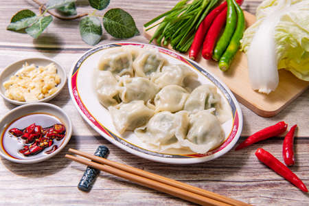 Boiled dumpling is Chinese dumplings or potstickers in boiling water. Dumpling is a dough and wrapped around a filling. The dough is flour and the filling is meat and vegetables.の素材 [FY310157323943]