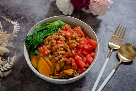 Delicious tomato spaghetti on the table (Served with cauliflower, pumpkin, Garland chrysanthemum) top viewの写真素材