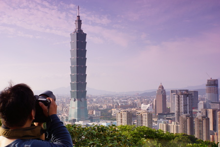 Photographer taking picture of 101 s picture under purple sky 