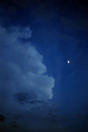 night time clouds with the g;ow of the moonの写真素材