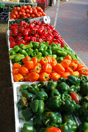 Peppers fill a table at the farmers marketの写真素材