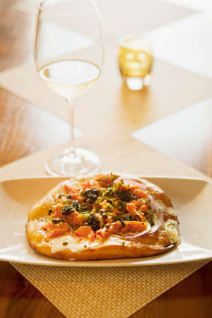 maple-smoked salmon pizza with lemon creme fraiche and a glass of sauvignon blanc wine, Root 246 Restaurant, Solvang, California, United States of Americaの写真素材