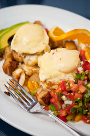 poached eggs over Dungeness crab cakes with chipotle Hollandaise sauce on a bed of roasted potatoes, Boathouse at Hendry's Beach, Santa Barbara, California, United States of Americaの写真素材
