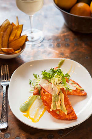 shrimp and crab empanadas with sweet fires and a glass of wineの写真素材