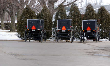 Amish parking lot in Shipshewana, IN.during the winter months.  Nice orderly arrangement of buggies symbolizes their straight forward life style.の写真素材