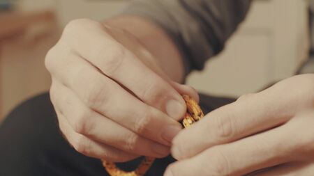 Mans hands tying a mountaineering knot on a rope