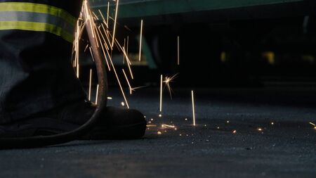 Close up of welding's sparks falling on the floorの写真素材