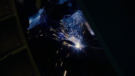Close up of welding. Manufacture of trucks. Worker welding metalの写真素材