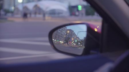 View of the city traffic in cars rearview mirrorの写真素材