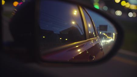 View of the city traffic in cars rearview mirrorの写真素材