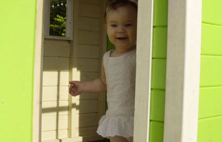 Baby girl hiding in the houseの写真素材