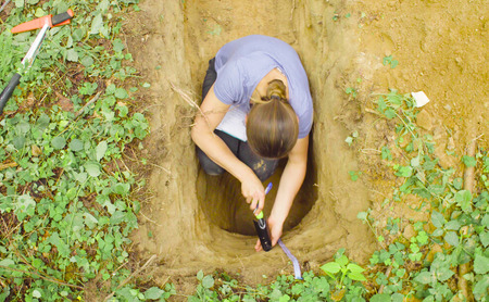 Woman ecologist taking samples of a soilの写真素材