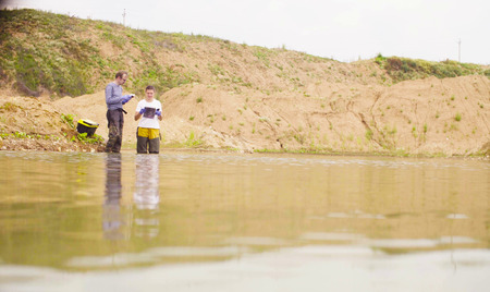 Two ecologists checking with the GPS navigatorの写真素材