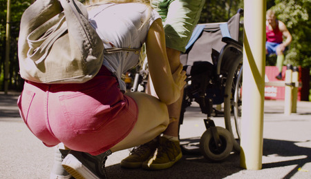Disable man in the park with his wife. Woman helping her disabled husbandの写真素材