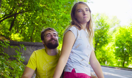 Young disable man on a walk in the park with his wife