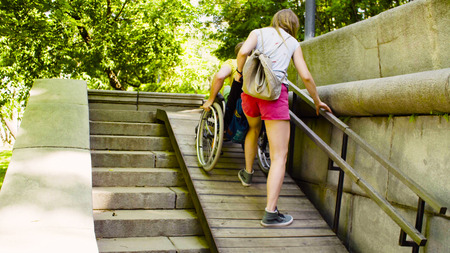 Young disable man with his wife on a walk in the parkの写真素材