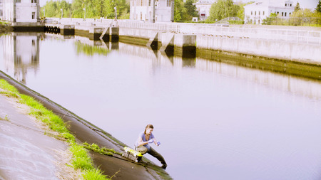 Ecologist getting samples of water in city riverの写真素材