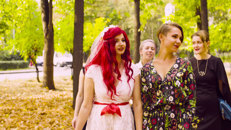Lesbian wedding. The bride and groom are walking in the parkの写真素材