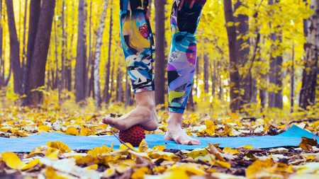 Woman doing foot massage with massage ballの写真素材