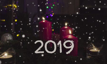 New Year card 2019. Burning candles and garland in a dark roomの写真素材