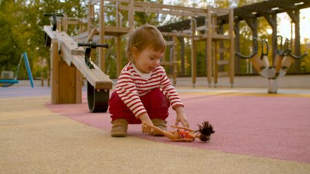 Little girl on the playground in the park. Good sunny dayの写真素材