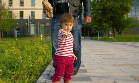 Funny daughter and her father in the parkの写真素材