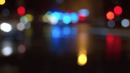 Blurred night city traffic lights. Rainy. Reflection of the colorful lights on the wet asphalt. City...