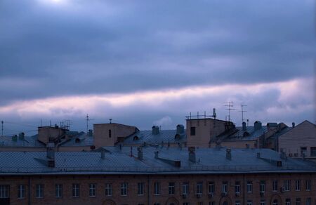 Dark cloudy sky over city buildings. Evening time, autumn. Sky backgroundの写真素材