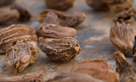 Macro shot of black dried cardamom seeds - famous aromatic spice. Extreme close upの写真素材