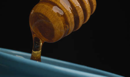 Honey pouring from honey spoonの写真素材