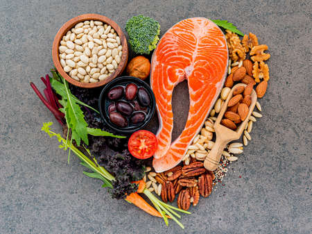Heart shape of ingredients for healthy foods selection on dark stone background.の写真素材