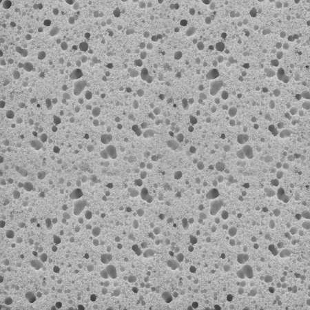 Gray texture of porous spongy material close-up. Abstract fabric background for design