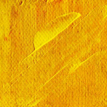 Abstract yellow orange acrylic hand paint background. Part of oil painting with brush strokes. Background of detail of yellow acrylic painting.の写真素材