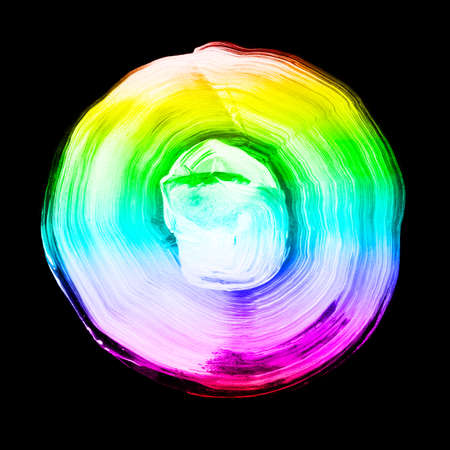 Rainbow textured acrylic circle. Watercolour stain with uneven edges isolated on black background. LGBT, gay and lesbian pride symbol. Round shape for logo template. Design element.の写真素材