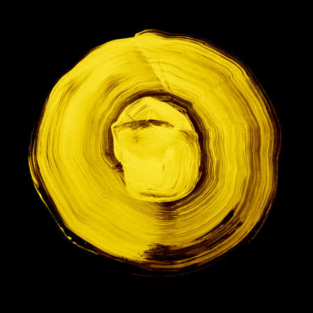 Yellow textured acrylic circle. Watercolour stain with uneven edges isolated on black background. Design element. Watercolor retro geometric round shapeの写真素材