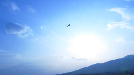 Plane with a blue sky and mountain background