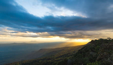 The  mountain ridges with sun light, sunset sky and the blurred rock forground.  Location place Phu Kra Dueng National park of Thailandの写真素材
