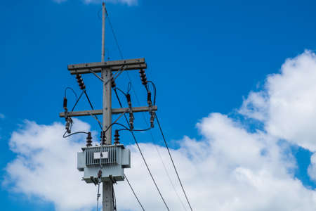 Electricity post and telephone line with blue sky backgroundの写真素材