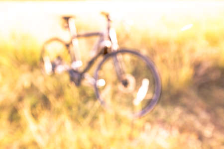 bike blur in the field on the sunset.の写真素材
