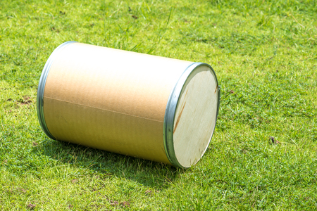 Wooden cylindrical tank on green lawn.の写真素材