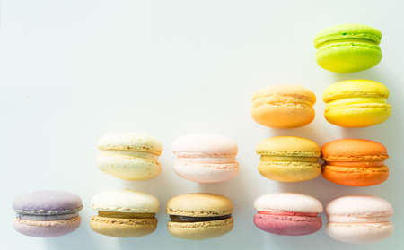Colorful macarons like graph increasing on white backgound, selective focusの写真素材