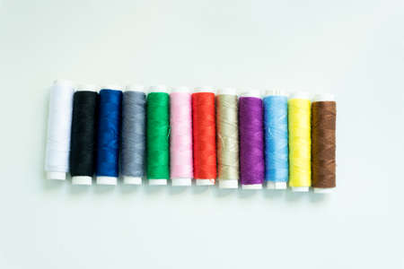 Spools of colours threads or call yarns on rolls for sewing isolated on white background