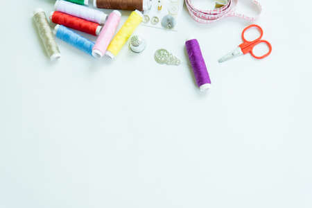Sewing accessories, tools ,colorful spools, needle and measuring tapeof thread with scissors...