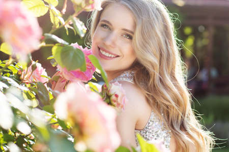 Fashion beauty girl with roses flowersの写真素材