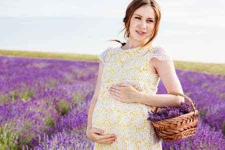 Beautiful pregnant woman in the lavender fieldの写真素材