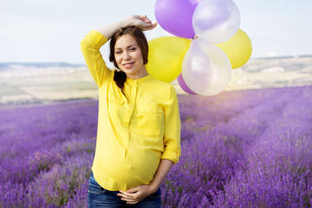 Beautiful pregnant woman in the lavender fieldの写真素材
