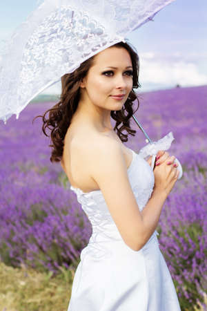 Beautiful bride posing at field of lavenderの写真素材